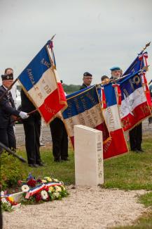 Porte-drapeaux rassemblés autour de la borne Aisne Terre de Mémoire avec gerbes de fleurs déposées à Flavy-le-Martel, lors de la cérémonie du 31 mai 2026